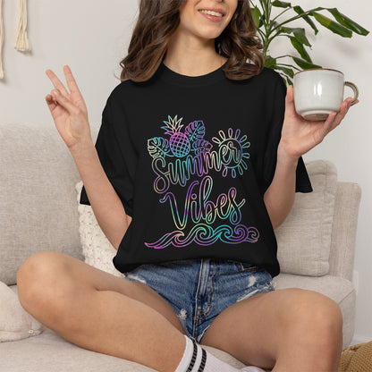 Person wearing a black t-shirt with 'Summer Vibes' design, sitting on a couch holding a mug.