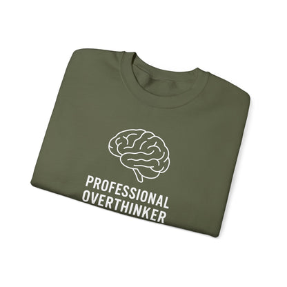 Folded military green t-shirt with a brain graphic and 'Professional Overthinker' text on a white background