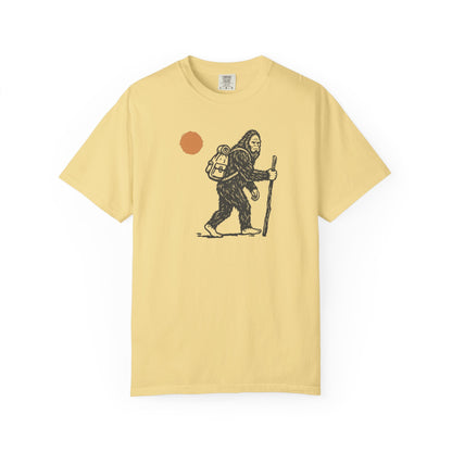 Bigfoot Hiker T-Shirt in Butter — Sasquatch with backpack sunset graphic tee