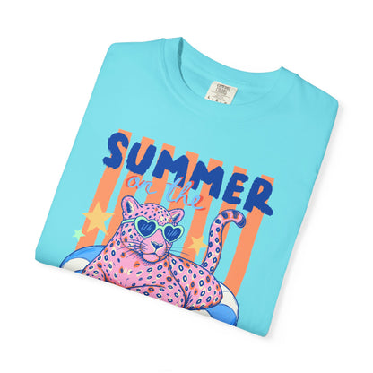Folded lagoon blue  t-shirt with a colorful design of a panther and 'Summer' text on a light blue background