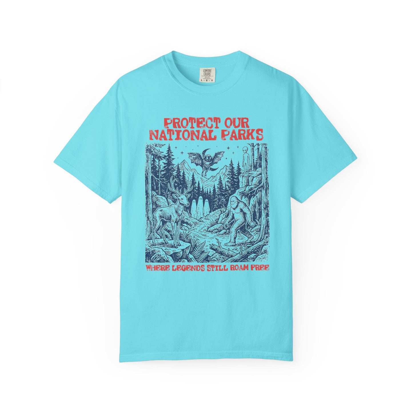 Comfort Colors® Protect Our National Parks cryptid graphic tee in Lagoon Blue — Bigfoot, Mothman, aliens, ghosts wilderness scene, flat lay