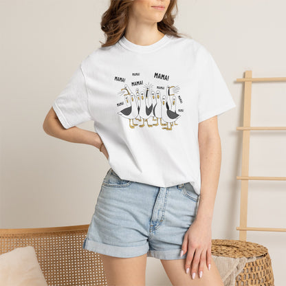 White t-shirt with cartoon penguins screaming "Mama"  design and text worn by a person.