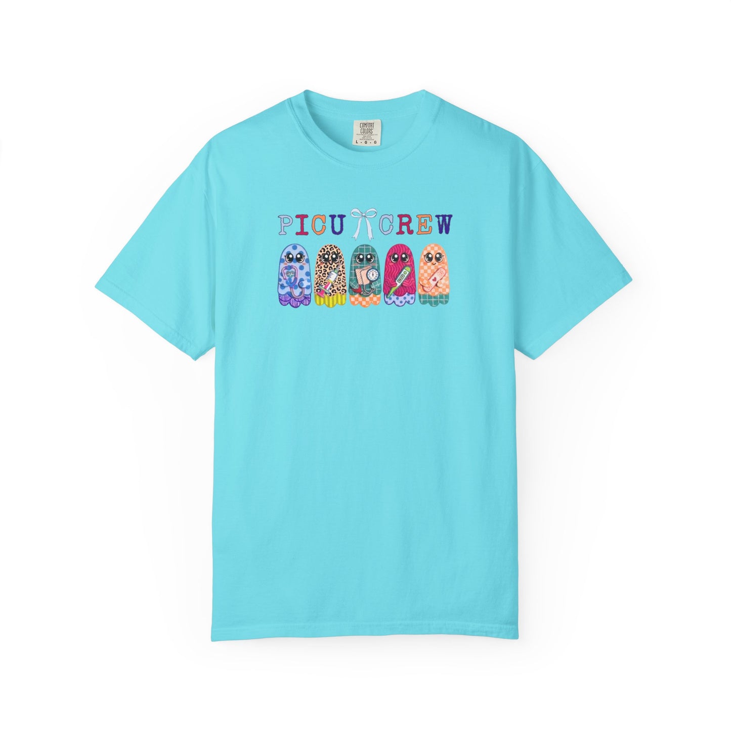 Lagoon Blue Comfort Colors PICU Crew t-shirt with five colorful patterned ghosts holding nursing tools — pediatric ICU nurse graphic tee, flat lay