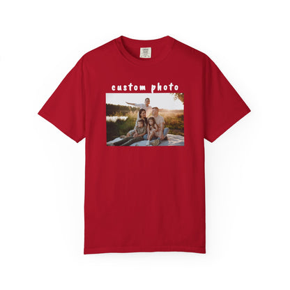 Red t-shirt with a printed photo of a family by a lake on a white background