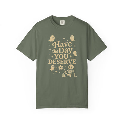moss t-shirt with Halloween-themed design and text that says "have the day you deserve" on a white background
