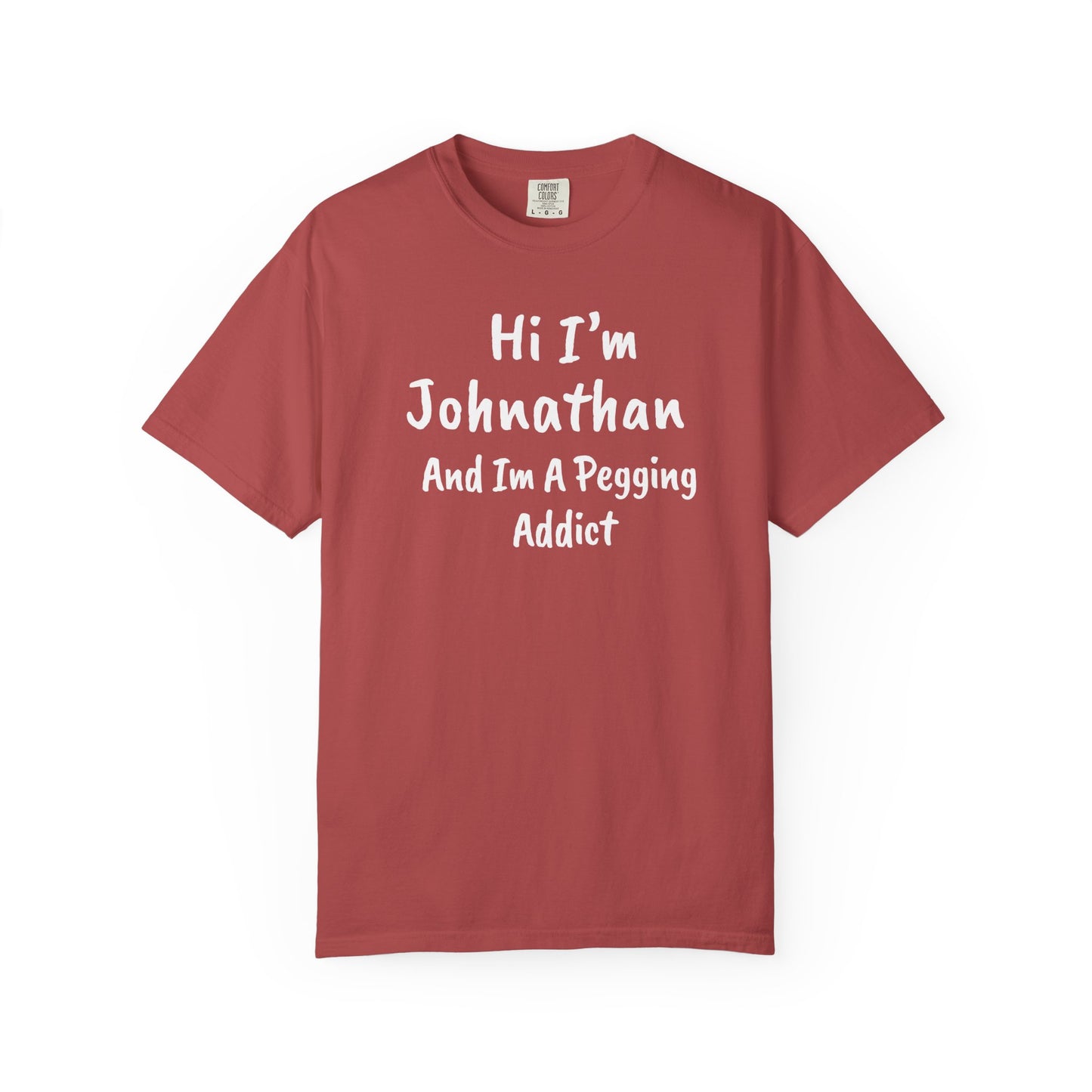 Crimson garment-dyed heavyweight t-shirt with personalized 'Hi I'm [Name] And I'm A Pegging Addict' graphic in handwritten-style font, centered on chest