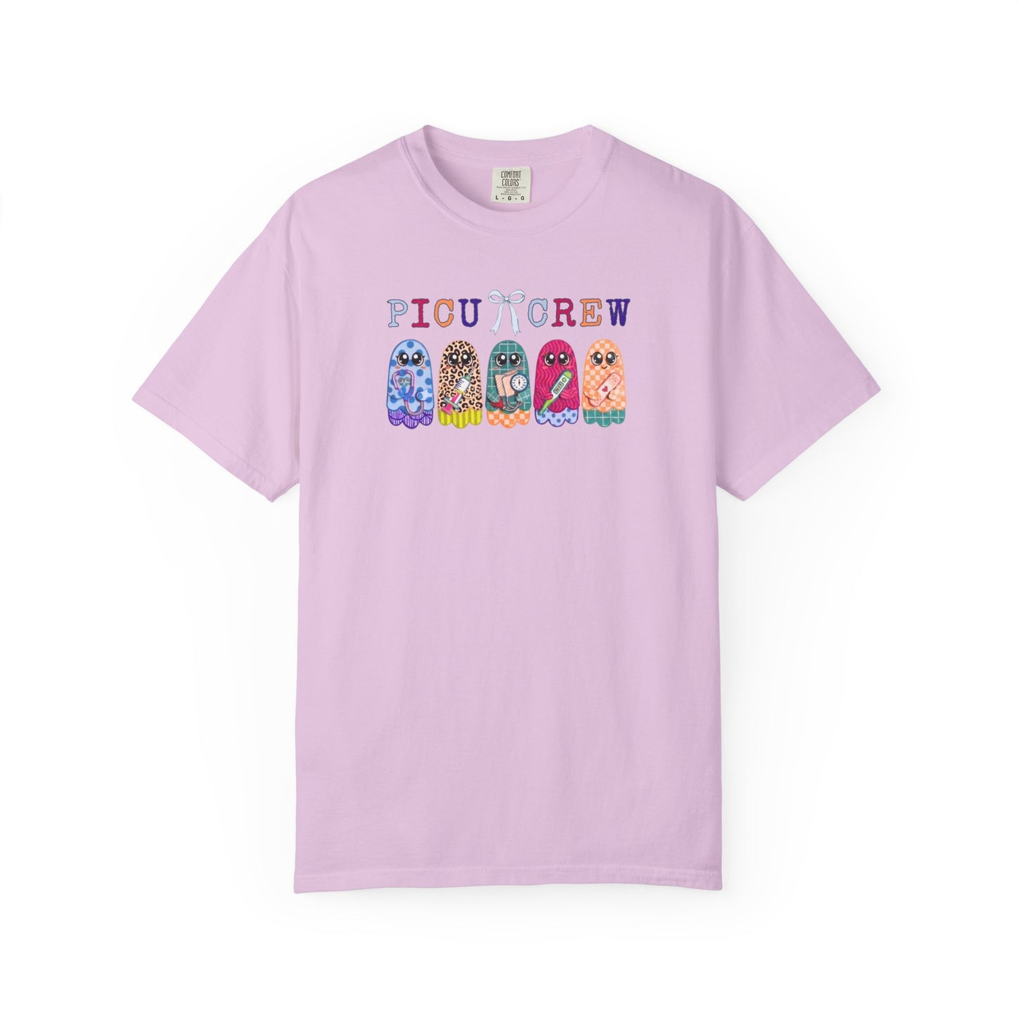 Orchid Comfort Colors PICU Crew t-shirt with five colorful patterned ghosts holding nursing tools — pediatric ICU nurse graphic tee, flat lay