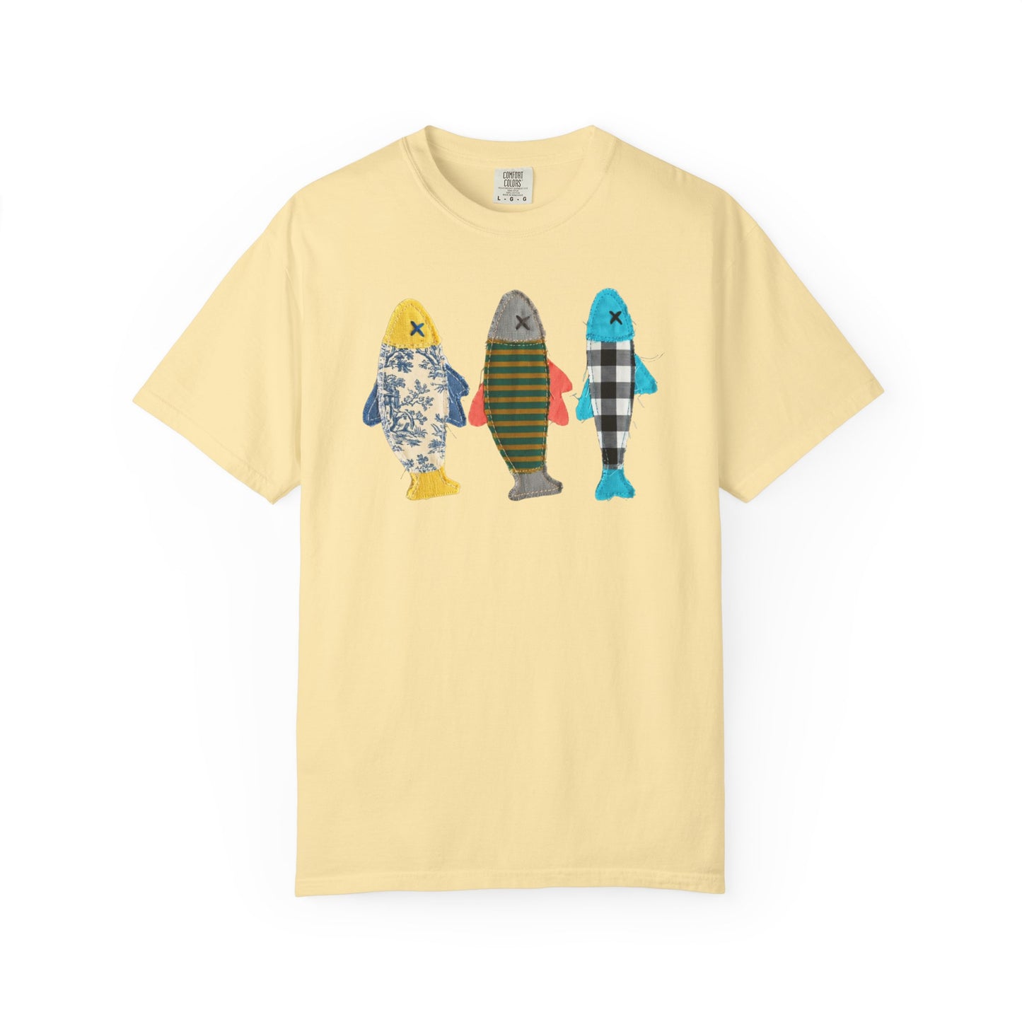 Faux patterned fish trio graphic tee in Banana Salmon showing the floral, stripe, and buffalo-check fish prints — color variant