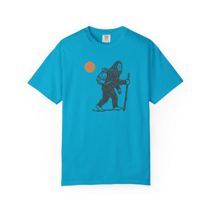 Bigfoot Hiker T-Shirt in Sapphire — Sasquatch with backpack sunset graphic tee