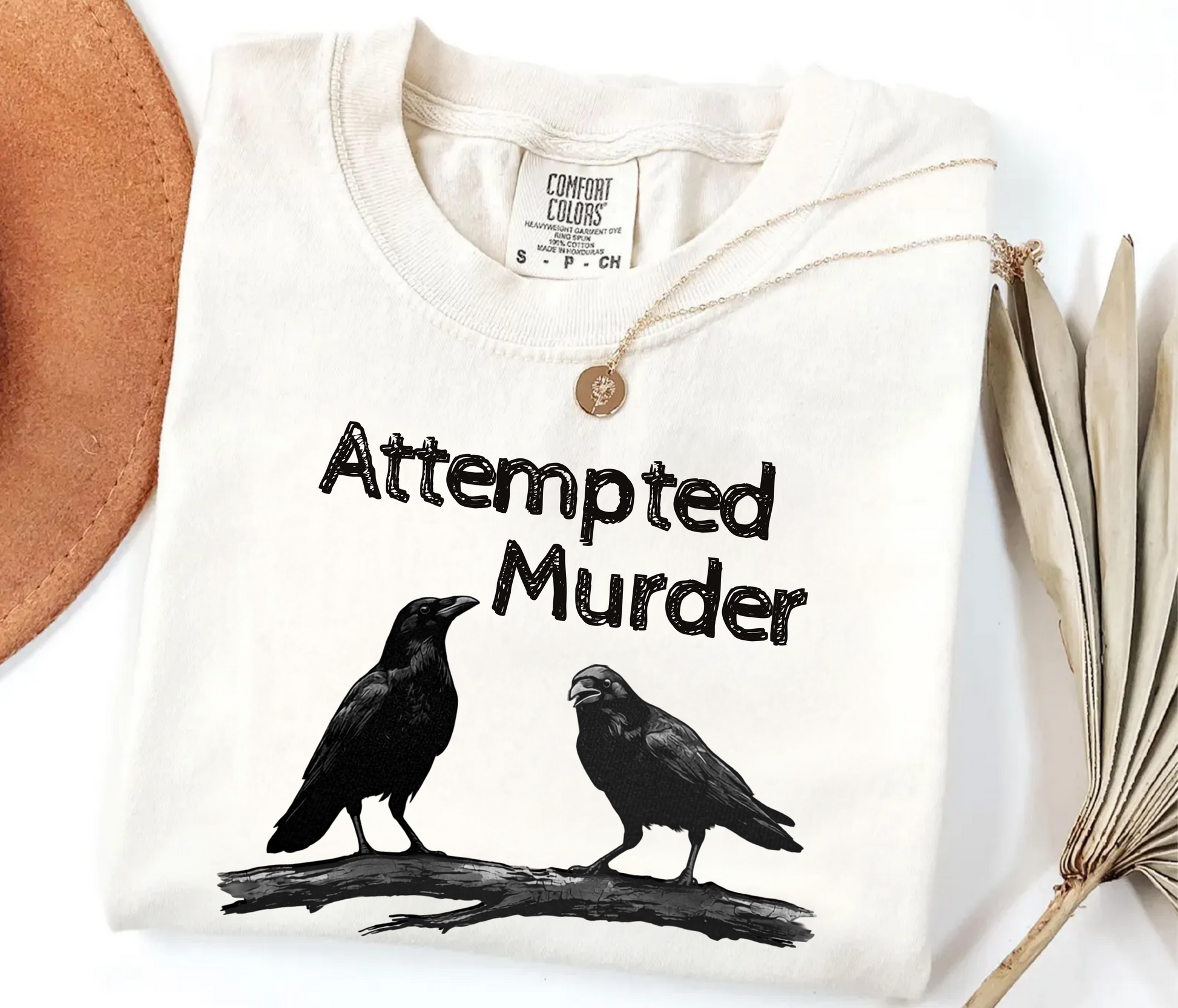 Ivory garment-dyed unisex crow graphic tee — Attempted Murder dark humor bird pun shirt