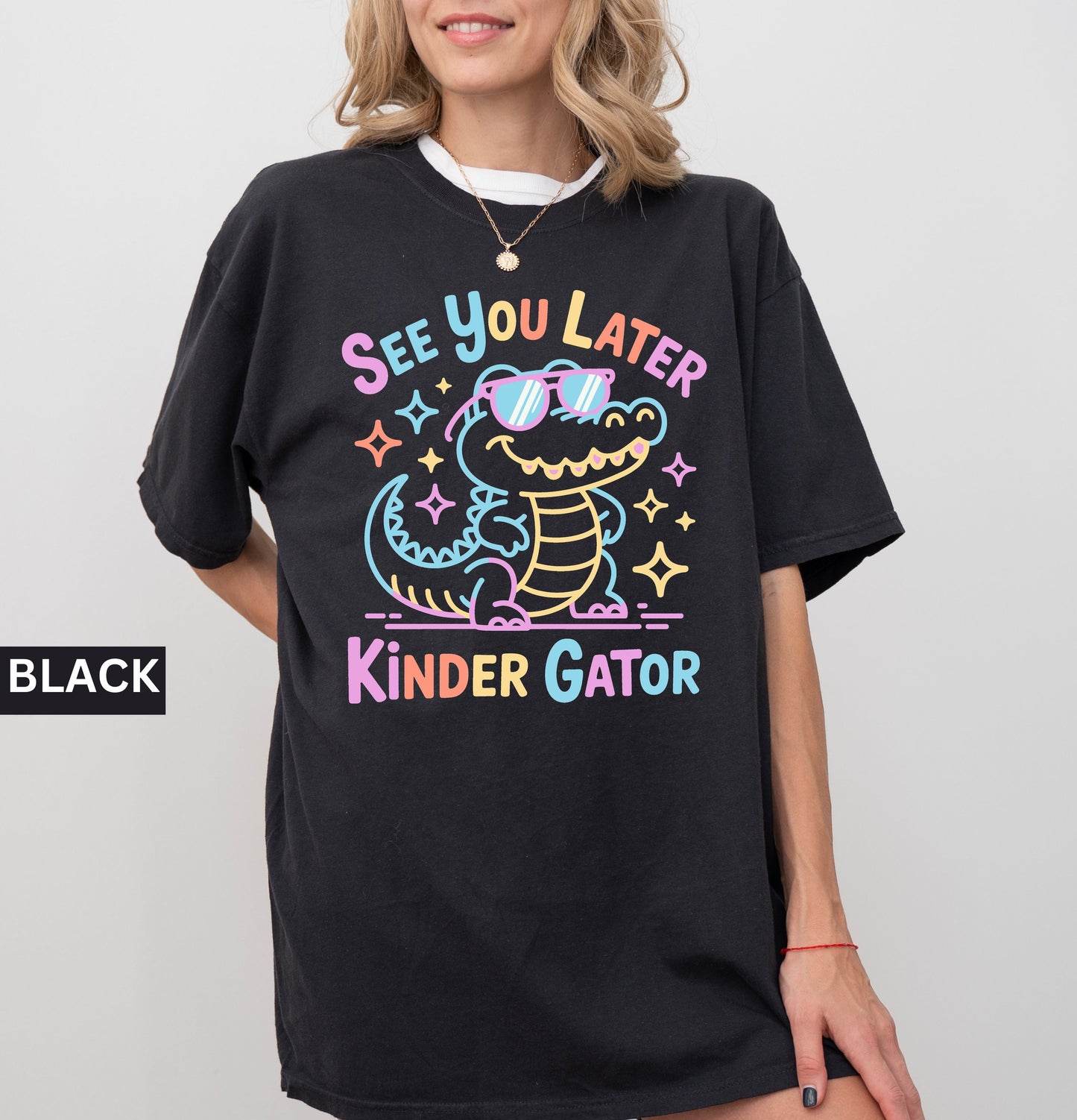 Black t-shirt with colorful 'Kinder Gator' design worn by a person on a plain background