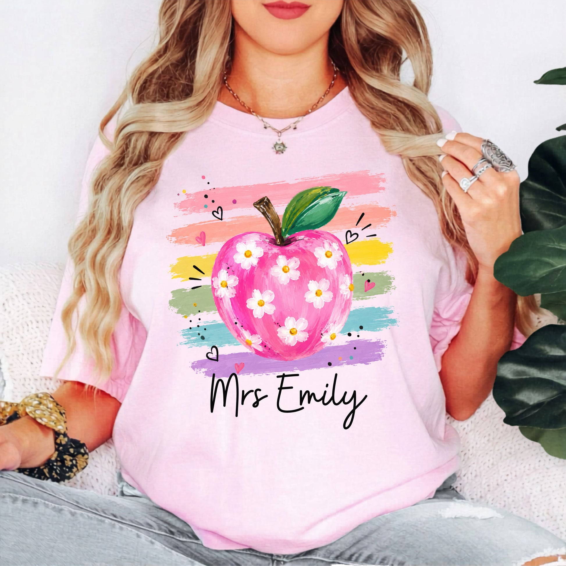 Personalized teacher t-shirt in Blossom with floral apple graphic and colorful brushstroke stripes, custom name in script — garment-dyed cotton tee